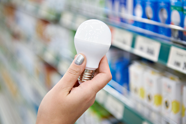 person holding smart lightbulb